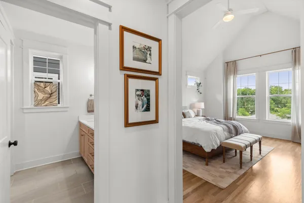 a bedroom with furniture and a large window