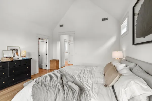 a bedroom with a bed and a tv on dresser