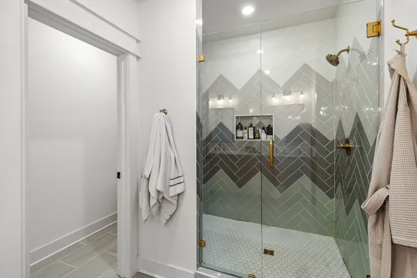 a bathroom with a glass shower door and a sink