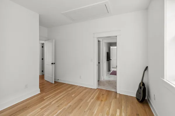 an empty room with wooden floor and a window