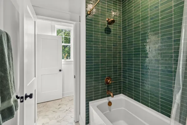 a bathroom with a bathtub and shower