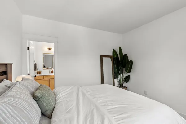 a bedroom with a bed and a dresser