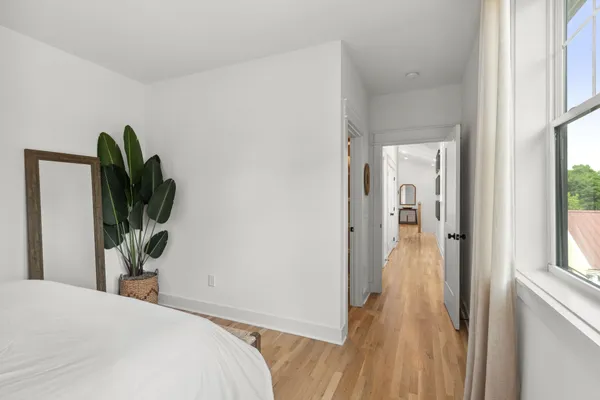 a bedroom with a bed and a mirror