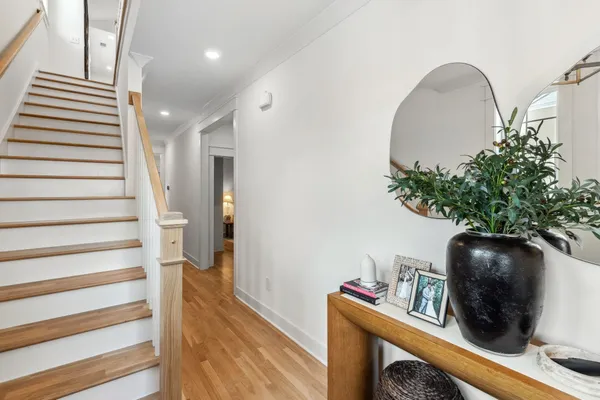 a view of entryway and hall with wooden floor