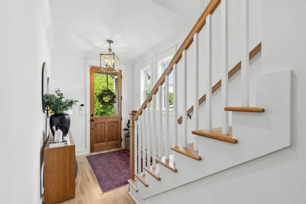 a view of entryway and hall with wooden floor