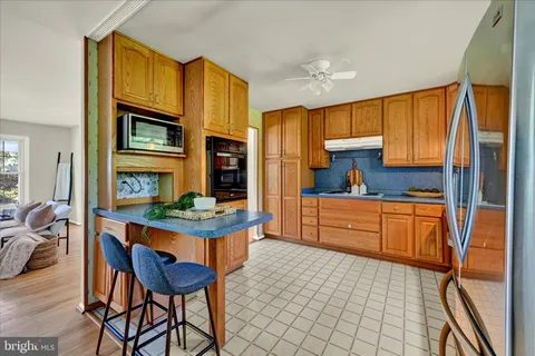 a kitchen with stainless steel appliances granite countertop a sink and cabinets