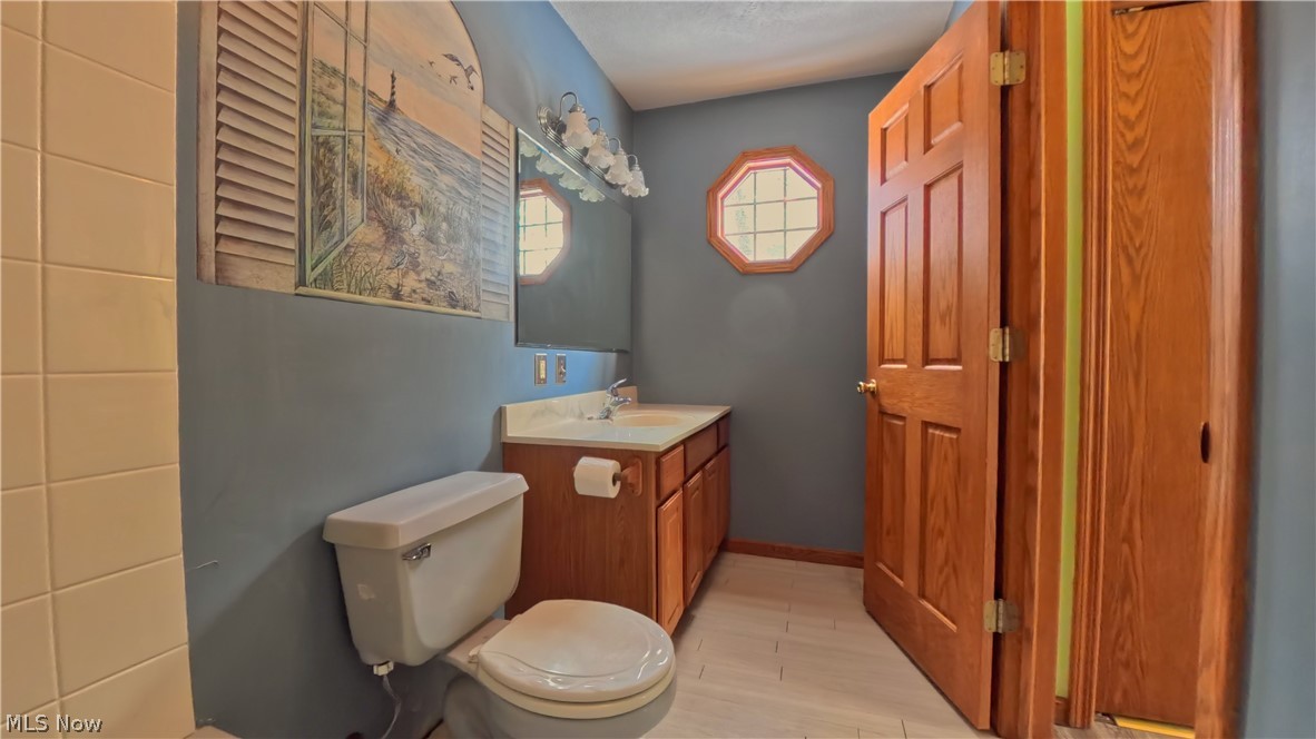 48276 Dyke Road Negley, OH 44441 - Photo 14 of 30 Half bathroom with vanity and toilet