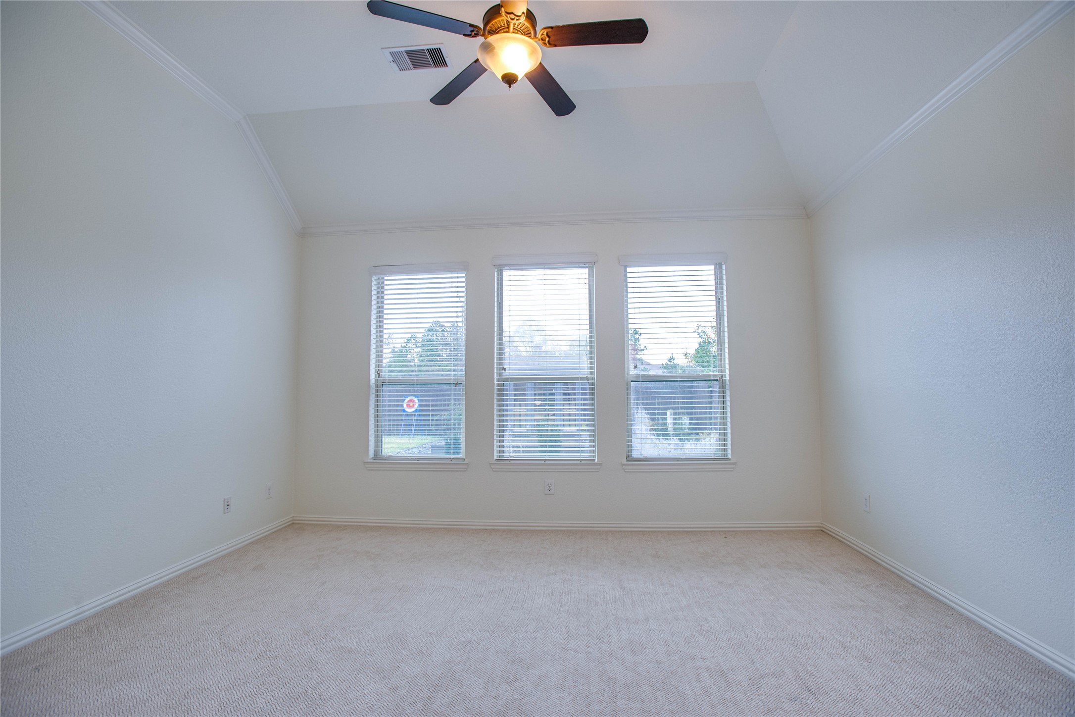 6210 Pinewood Heights Drive Spring, TX 77389 - Photo 13 of 24 an empty room with chandelier fan and windows