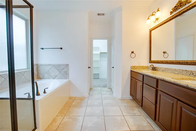 a bathroom with a granite countertop sink a toilet and shower