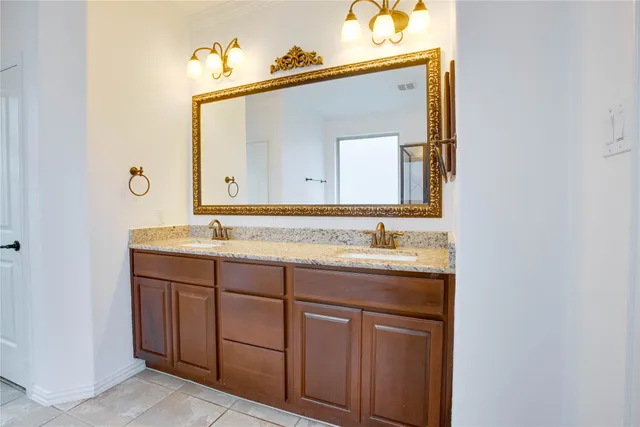 a bathroom with a double vanity sink and a mirror