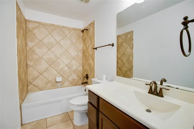 a bathroom with a sink a toilet and shower curtain