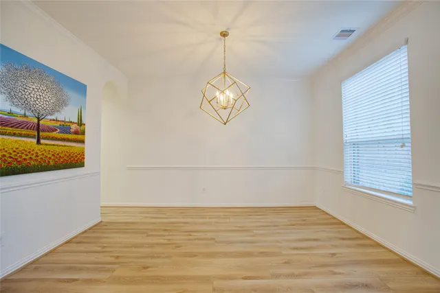a view of a room with wooden floor and window