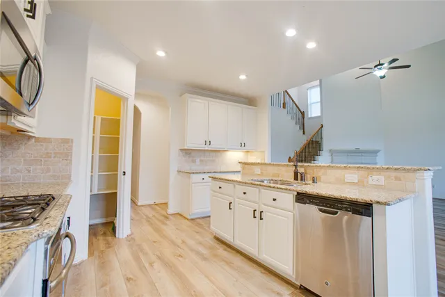 a kitchen with a sink stove and cabinets