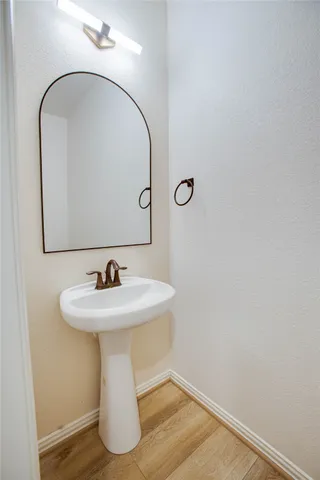 a bathroom with a sink and mirror