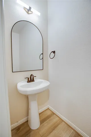 a bathroom with a sink and mirror