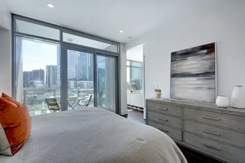 a bedroom with a large bed and a large window
