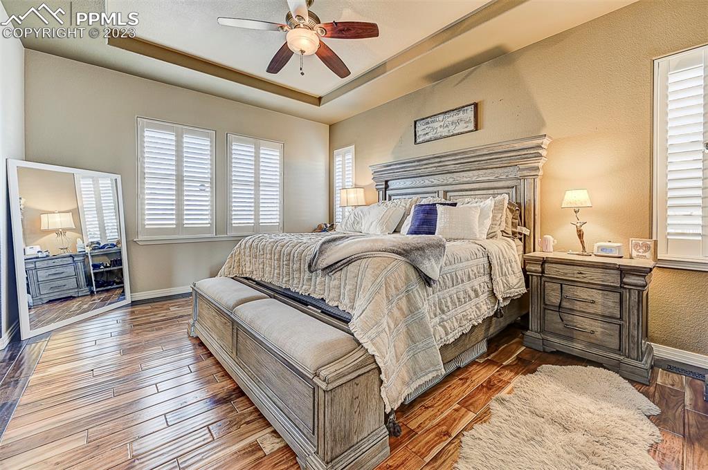 7555 Antelope Meadows Circle Peyton, CO 80831 - Photo 5 of 7 a bedroom with a bed and wooden floor