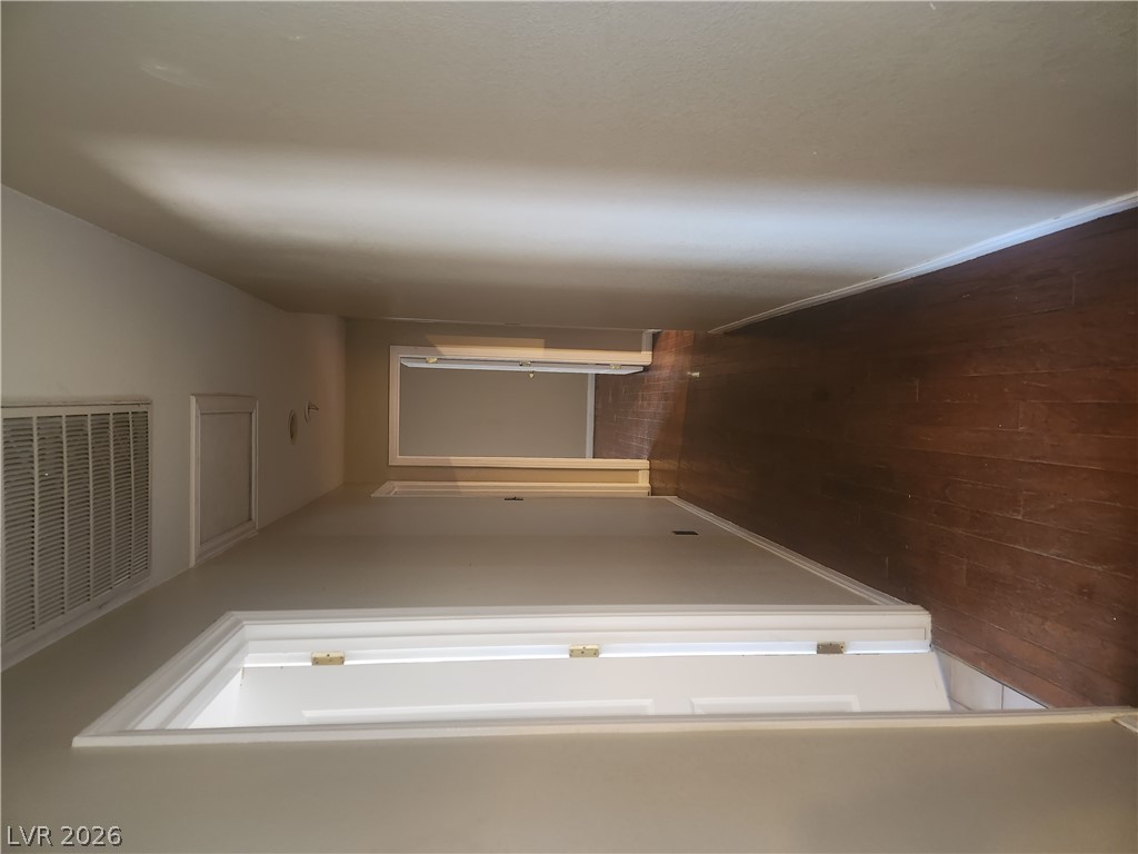 564 Ridgeway Road Henderson, NV 89015 - Photo 8 of 22 Rich wood flooring defines a long hallway connecting various private spaces.
