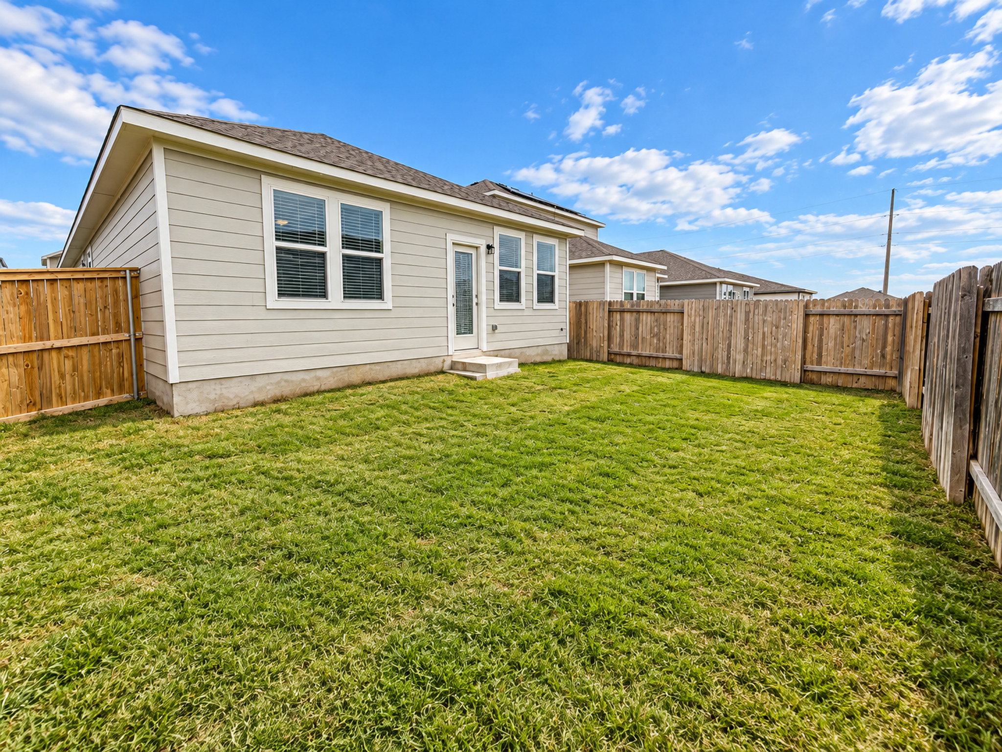 213 Escape Way Jarrell, TX 76537 - Photo 14 of 15 A fully fenced lawn offers a secure outdoor area behind the siding exterior.