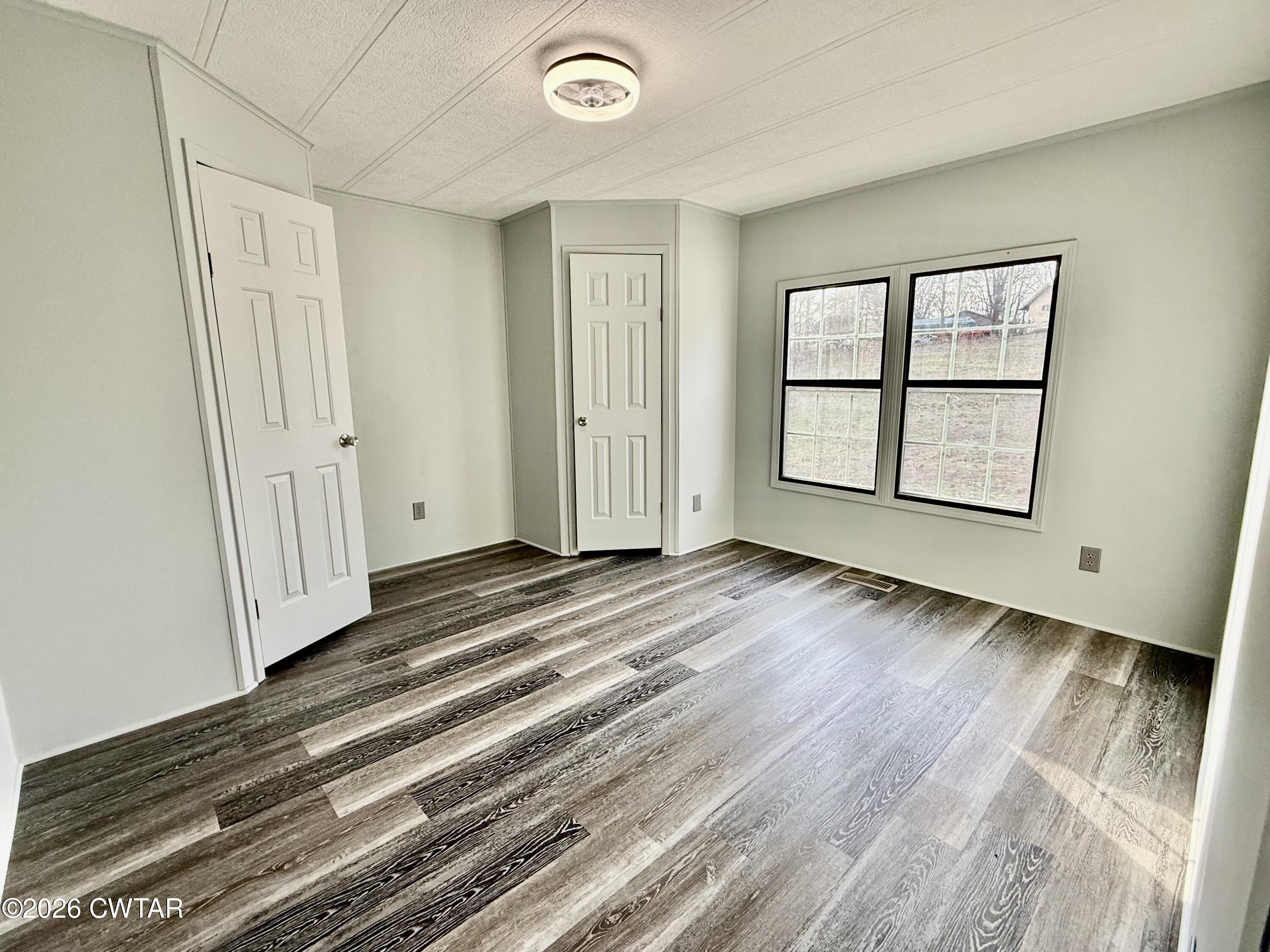 0 Antioch Church Road Hornbeak, TN 38232 - Photo 11 of 18 an empty room with wooden floor and windows