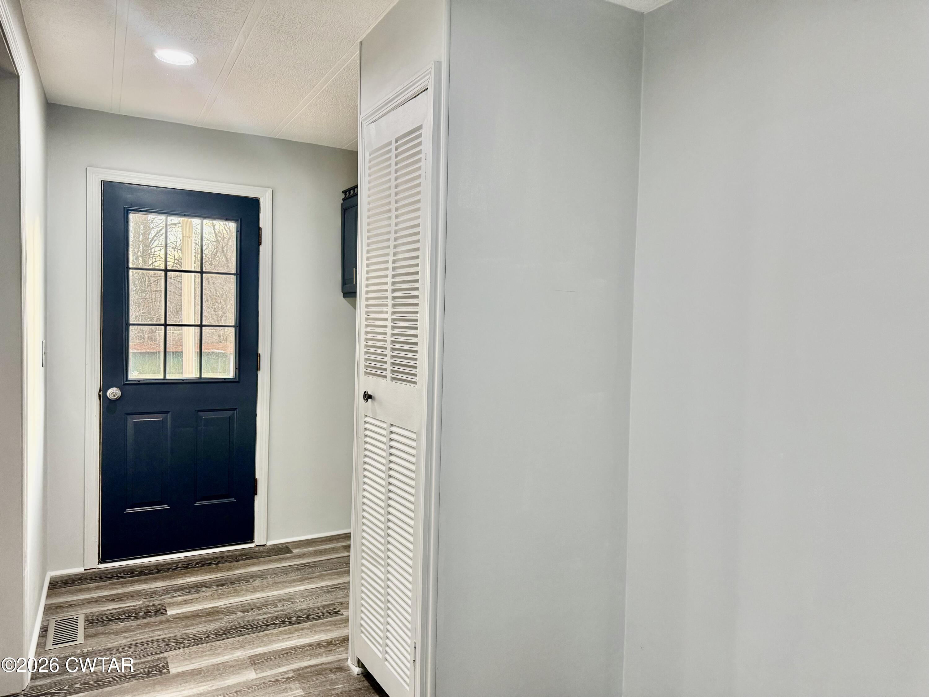 0 Antioch Church Road Hornbeak, TN 38232 - Photo 13 of 18 a view of a hallway with wooden floor and windows
