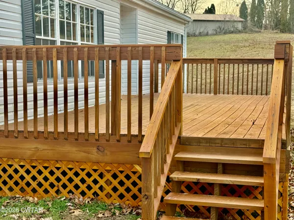 a view of a balcony with wooden fence
