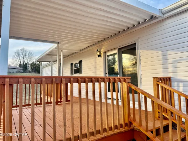a view of a porch with wooden floor