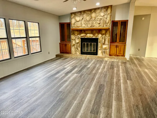 wooden floor fireplace and windows in a room
