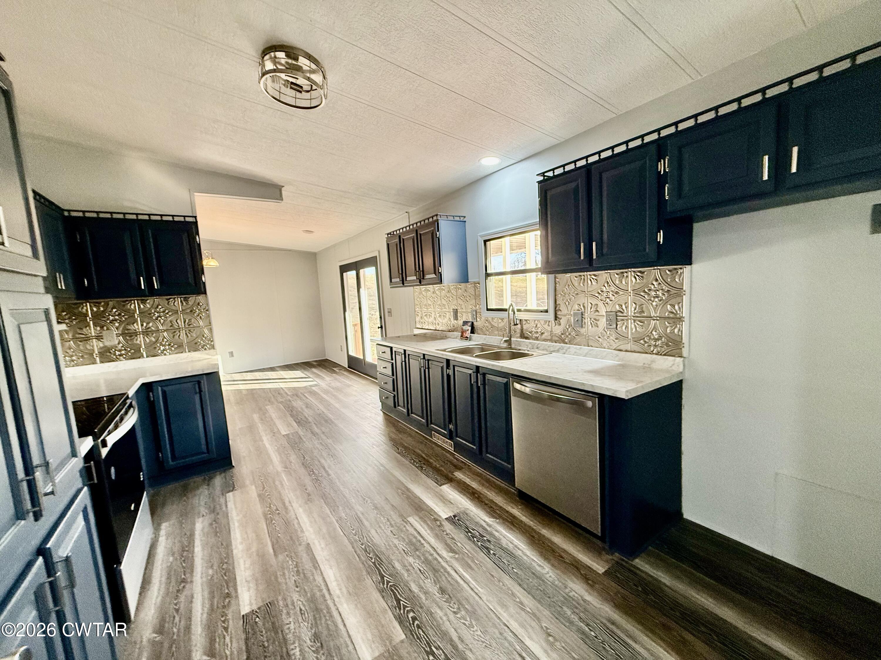 0 Antioch Church Road Hornbeak, TN 38232 - Photo 5 of 18 a kitchen with stainless steel appliances granite countertop a sink stove and microwave
