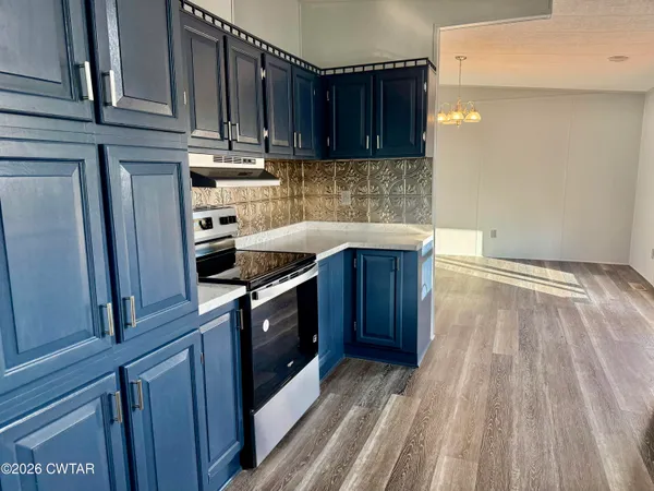 a kitchen with a sink a stove and cabinets