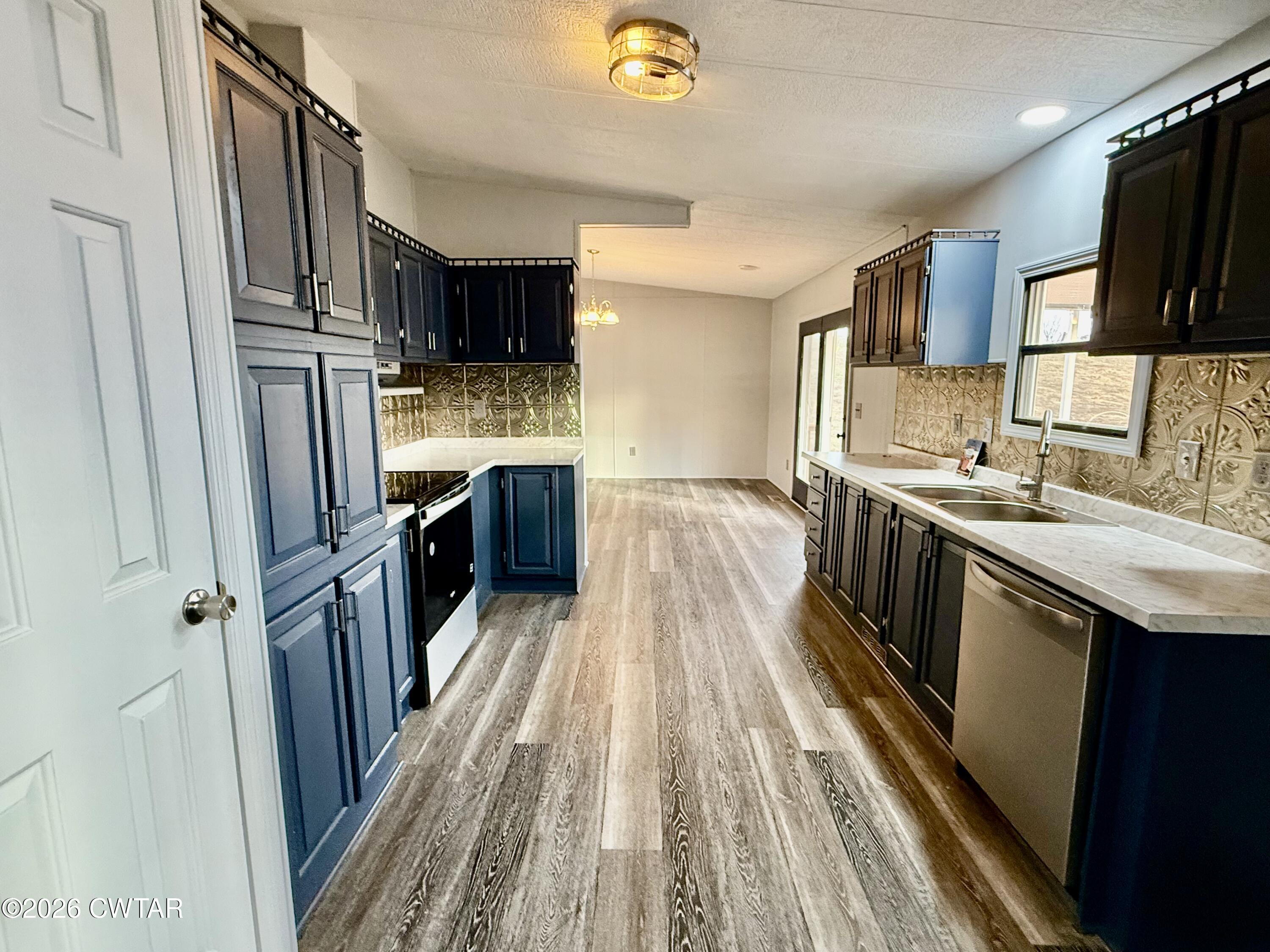 0 Antioch Church Road Hornbeak, TN 38232 - Photo 8 of 18 a kitchen with stainless steel appliances granite countertop a refrigerator a stove a sink and a microwave