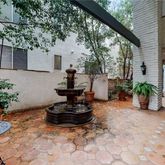 a view of a backyard with plants and a patio