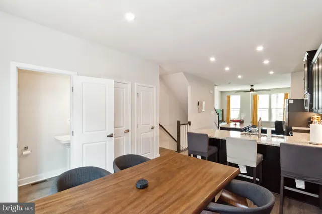 a kitchen with a table chairs refrigerator and cabinets