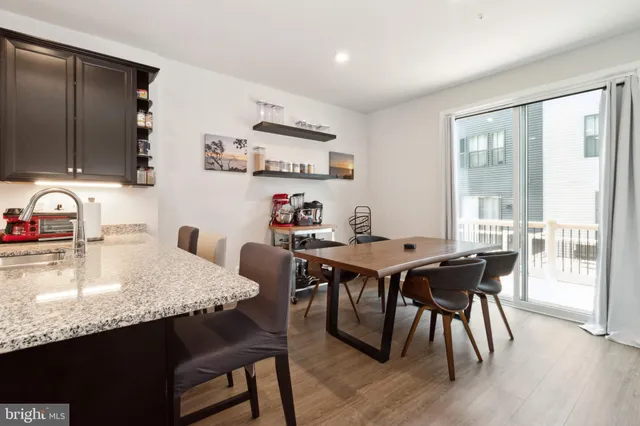 a dining room with furniture and wooden floor