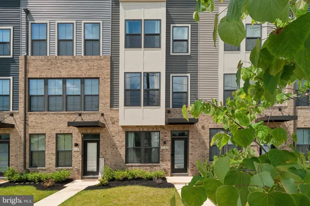 a view of a brick building next to a yard