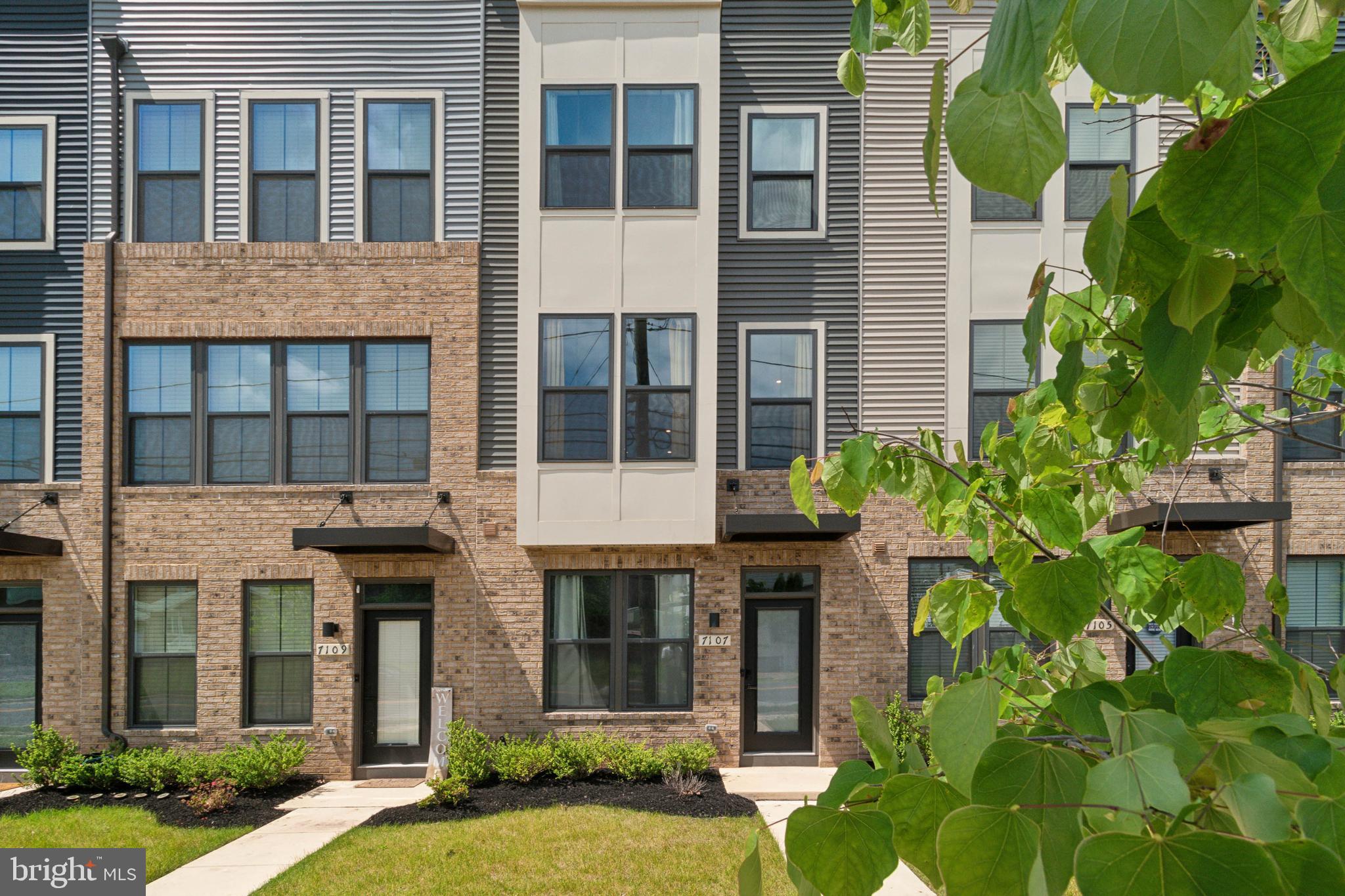 7107 Sollers Point Road Dundalk, MD 21222 - Photo 2 of 25 a view of a brick building next to a yard