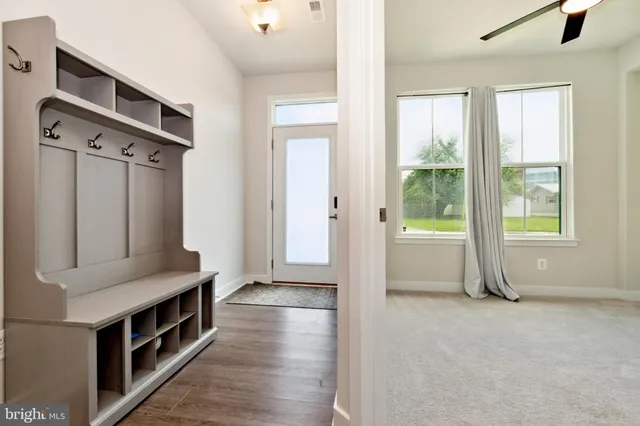a view of an entryway with wooden floor