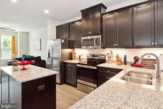 a kitchen with refrigerator cabinets and wooden floor