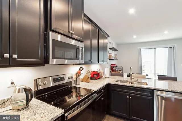 a kitchen with a sink stove and microwave