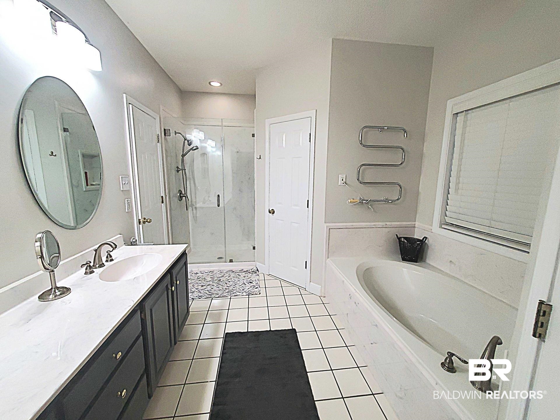 31163 Woodland Way Daphne, AL 36527 - Photo 13 of 44 Bathroom with tile patterned floors, plus walk in shower, and vanity