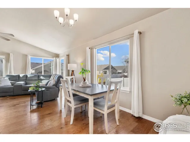 a dining room with furniture window and wooden floor