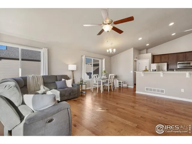 a living room with furniture and kitchen view
