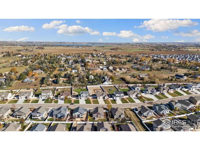 an aerial view of a house with a lot of trees in front of it