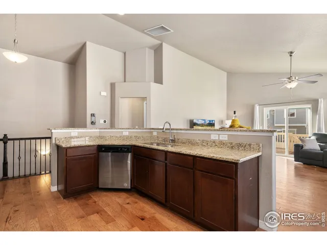 a kitchen with granite countertop a sink and cabinets