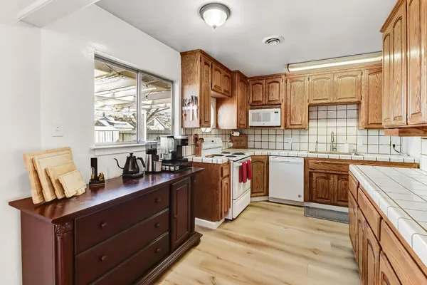 a kitchen with a sink stove and cabinets