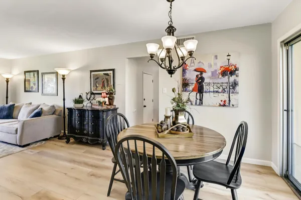 a view of a dining room with furniture wooden floor and chandelier