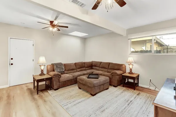 a living room with furniture and a chandelier