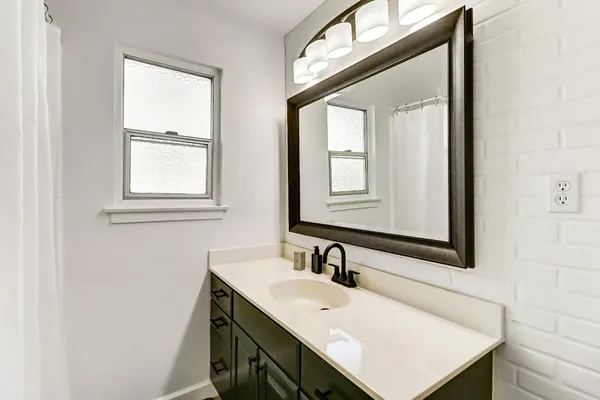 a bathroom with a sink vanity and a mirror