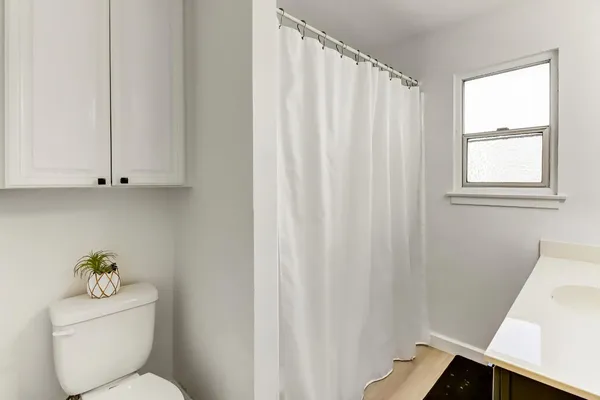 a bathroom with a toilet and shower