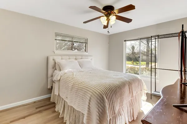 a bedroom with a large bed and a chandelier